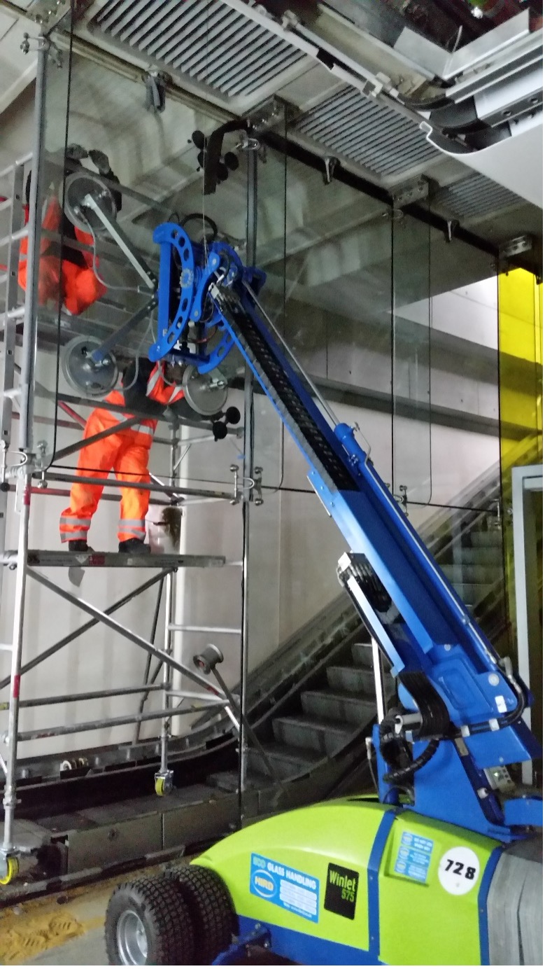 Vacuum lifting equipment being used to install an internal glass panel