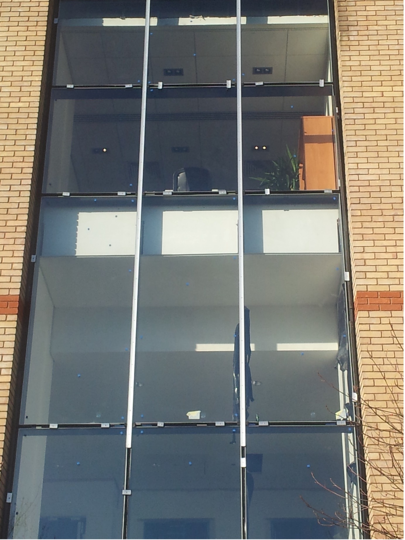 Office building with a newly installed structural glass facade in Derby